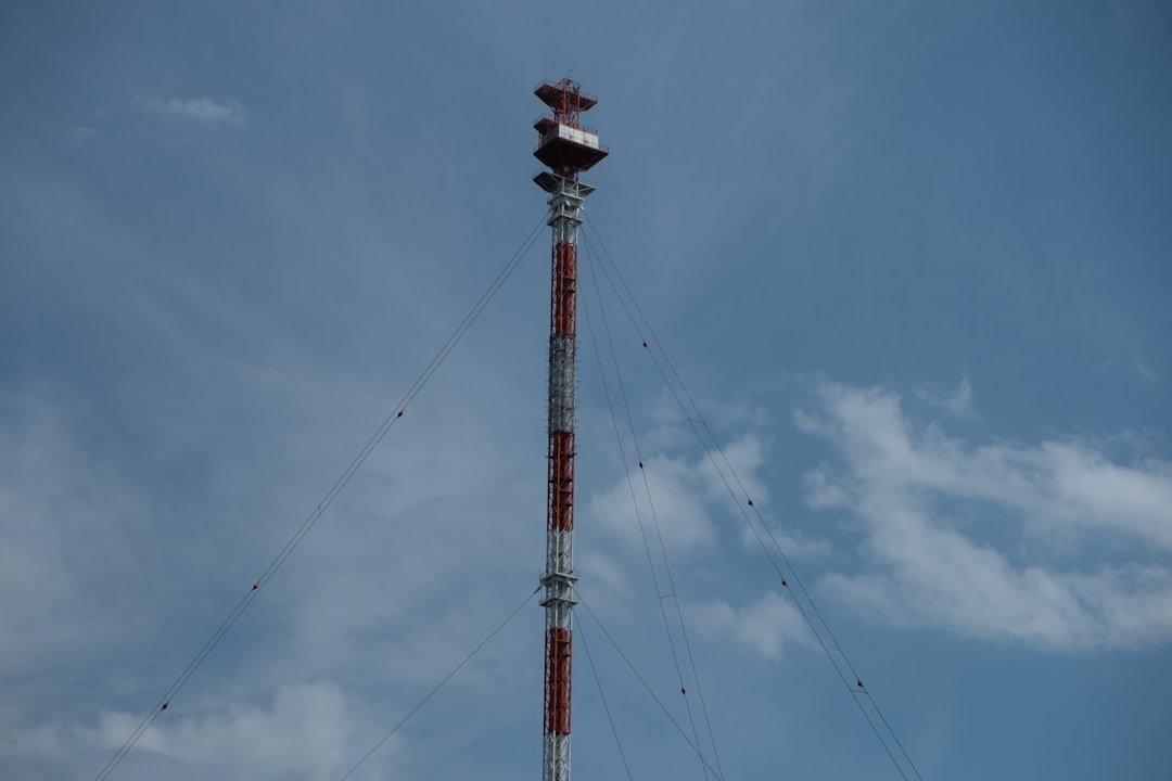 hero-about red-and-white-metal-tower-under-blue-sky-takzbbfbds0